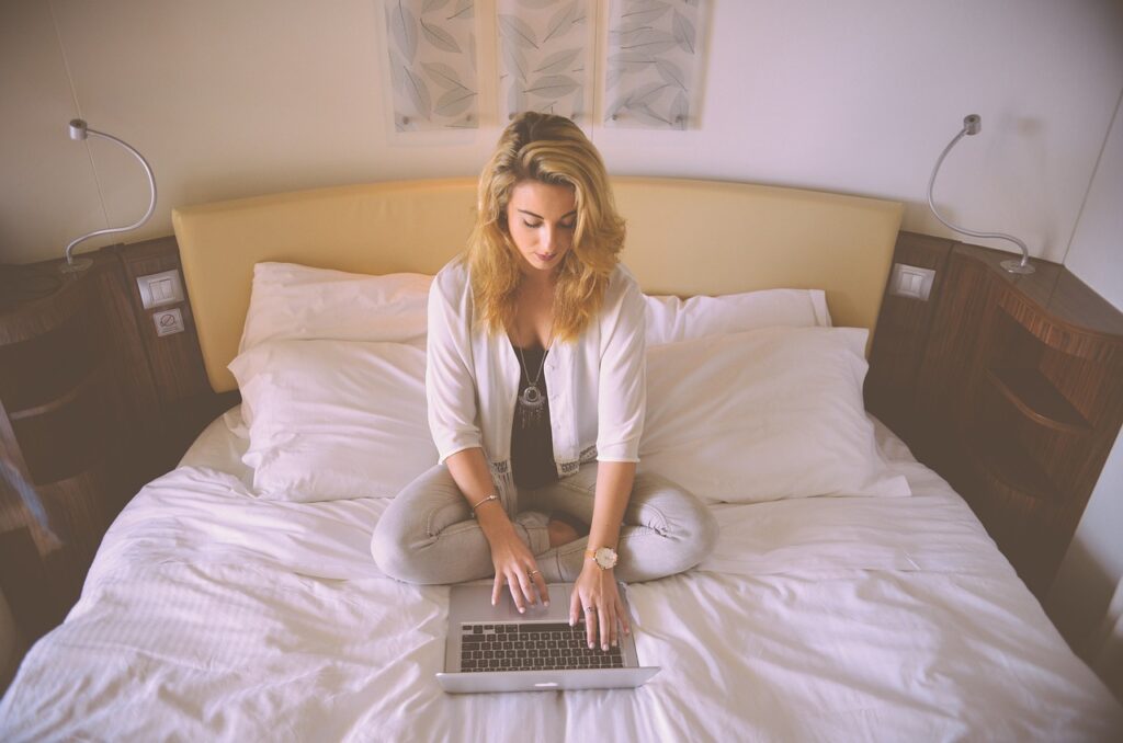 woman working bed laptop typing 731894